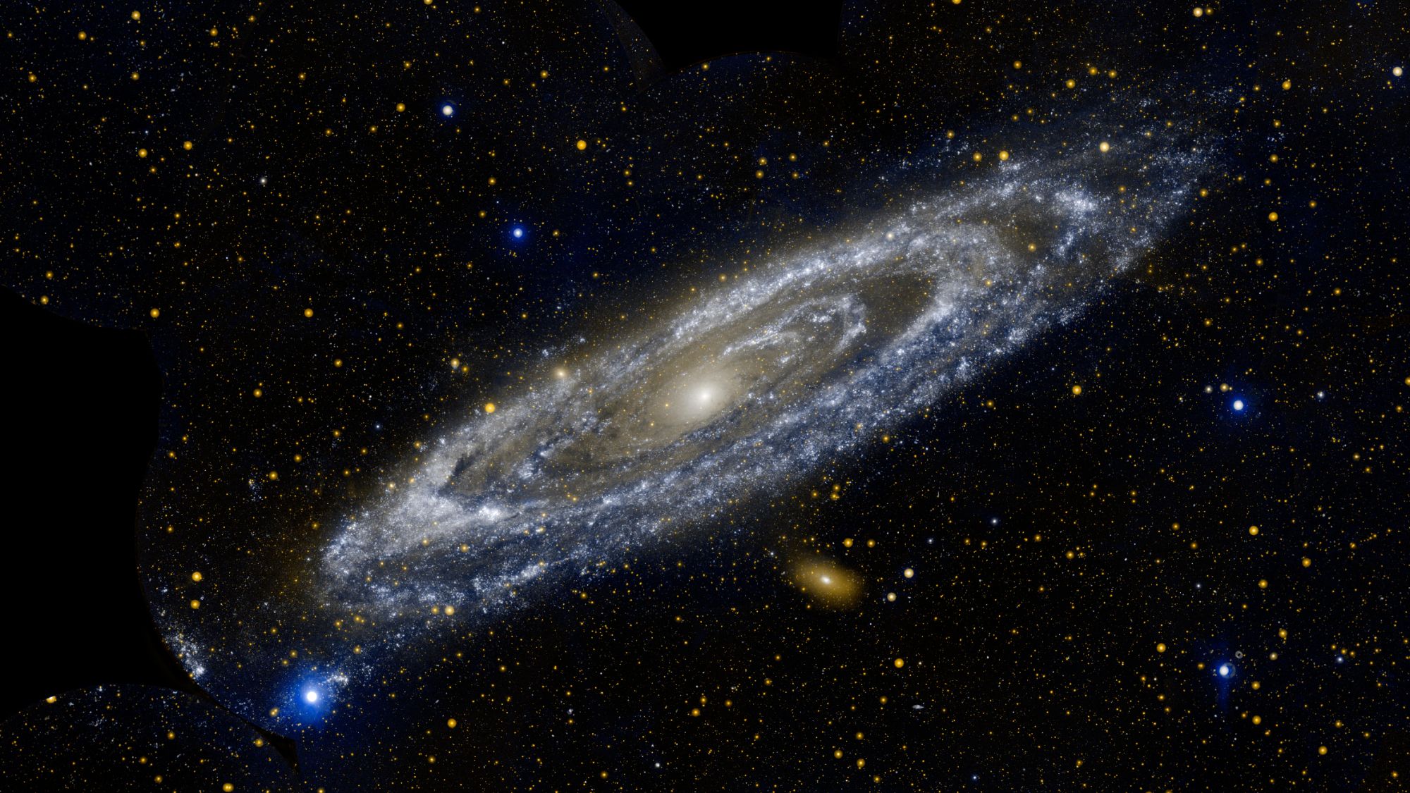 A beautiful white and blue spiral galaxy is seen slightly edge-on with a vast black section of space behind it. There are glowing dots and orbs all across the darkness.