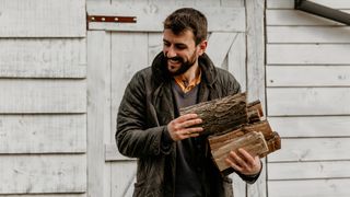 how to season wood: man with firewood stack