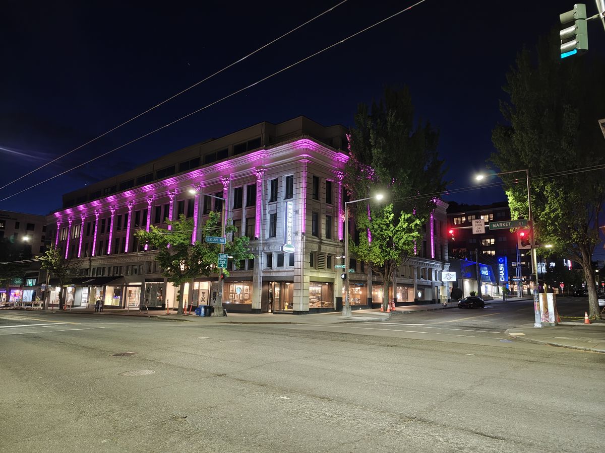 A building lit up a night with purple lights