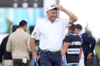 Lee Westwood on final green removing hat