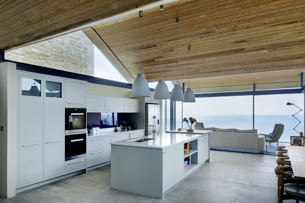 glass extension with white kitchen and modern living room