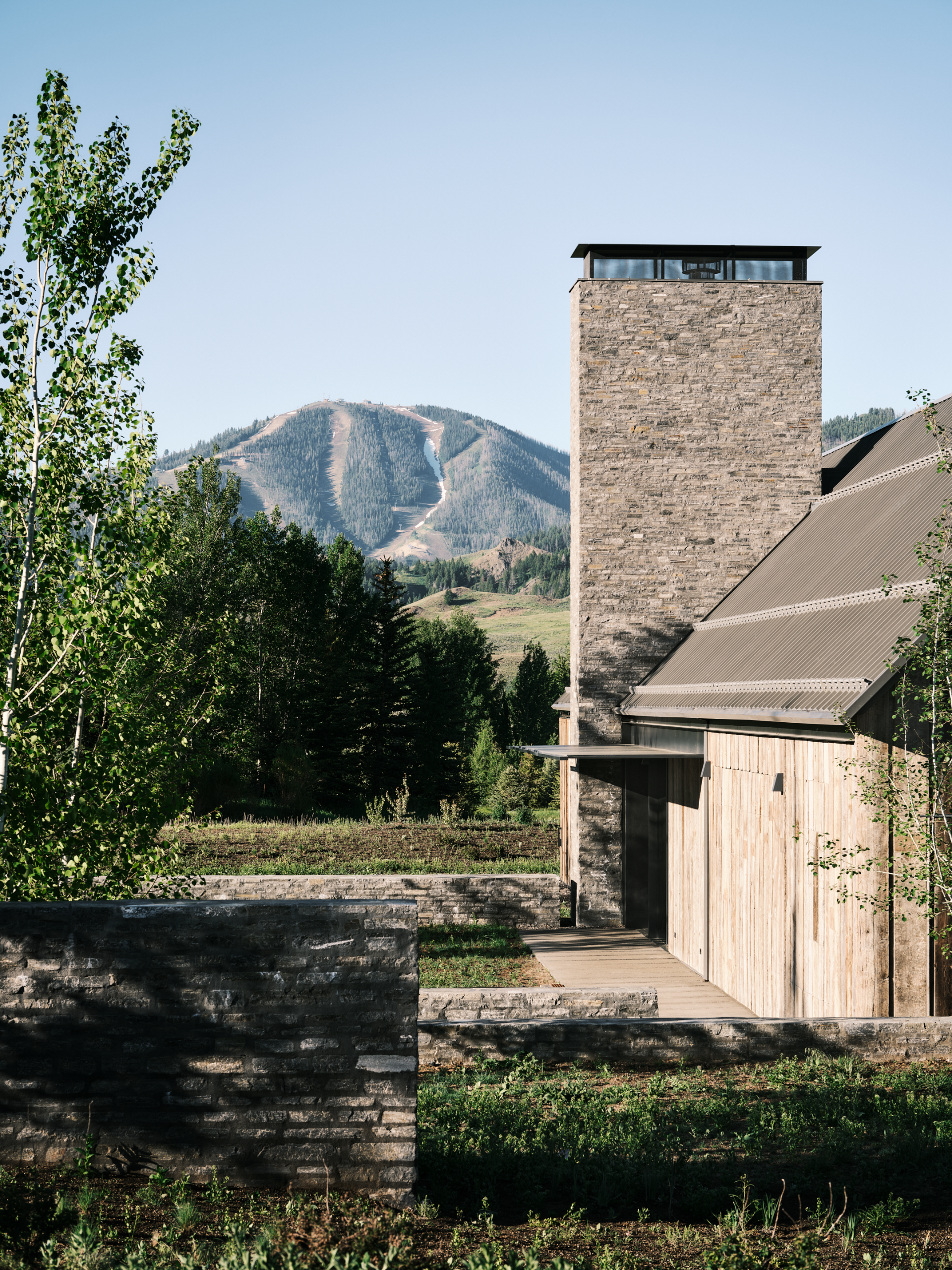 Three Barns by Field Architecture, a rural american home designed to look like a collection of old wooden barns