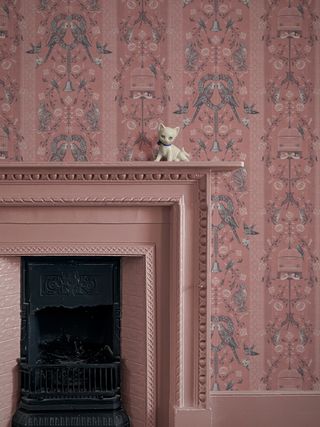 pink skirting board and fireplace with patterned wallpaper