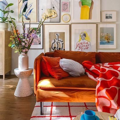 Colorful living room with orange couch that fits into 2023 interior design trends