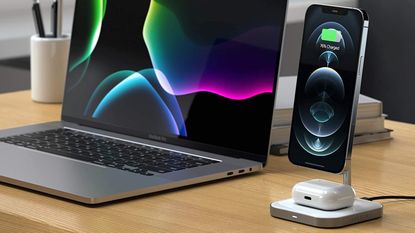 Satechi Aluminium 2-in-1 wireless charger for iPhone on a desk next to a MacBook computer