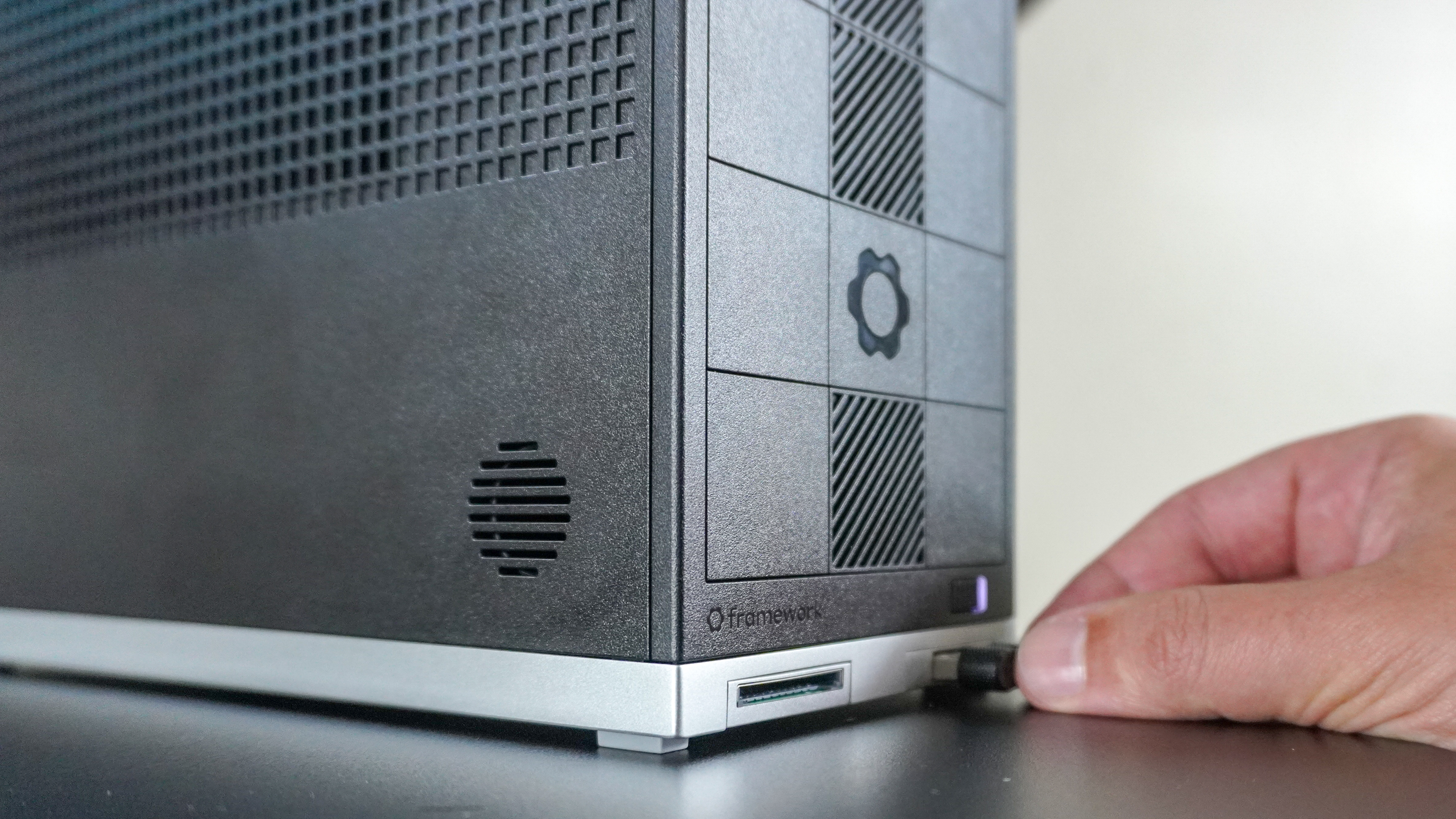Plugging a flash drive into the front of the Framework Desktop