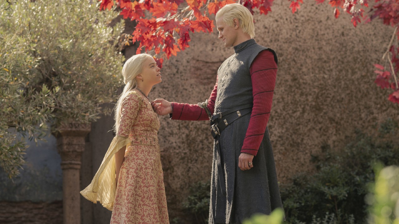 Milly Alcock as Rhaenyra Targaryen and Matt Smith as Daemon Targaryen standing together in a garden in episode 4 of House of the Dragon.