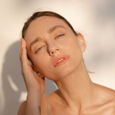 Close-up image of a woman with hydrated skin in the sunlight