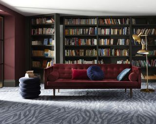 Home library design with zebra print carpet and velvet sofa by Carpetright
