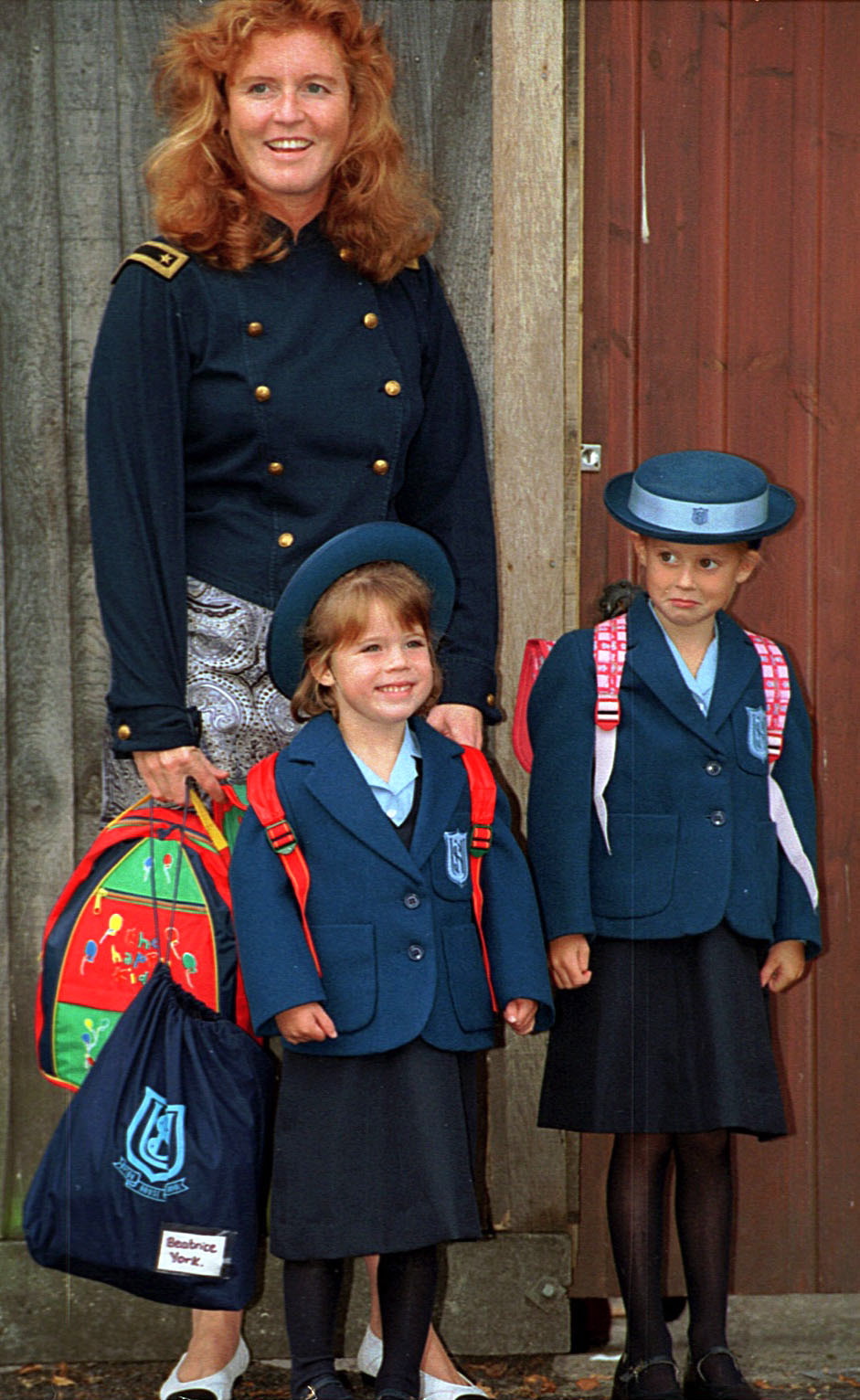 Sarah Ferguson standing with Princess Eugenie and Princess Beatrice in their school uniforms