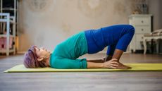 Woman performing bridge exercise in a domestic setting