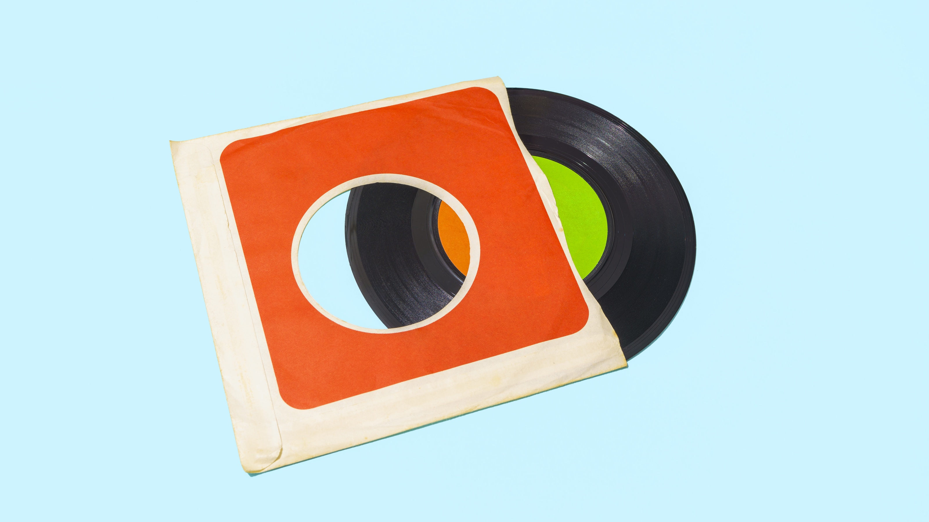 An old vinyl record halfway out of its sleeve.