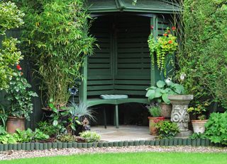 Green painted garden arbor in backyard