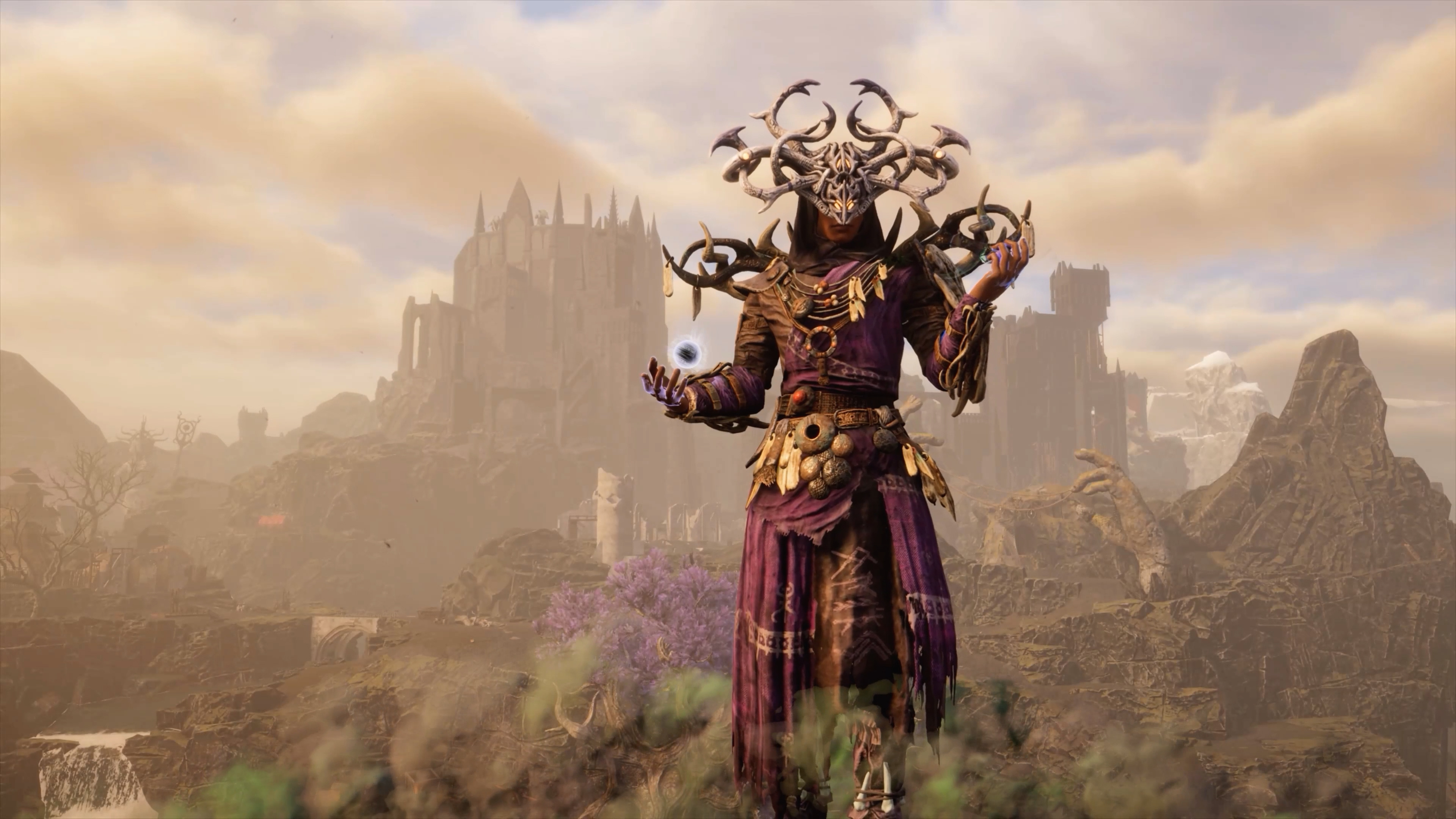 A mage wearing purple robes and a bone headdress stands on a mountain. A ruined castle crouches in the background.