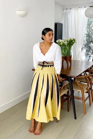 Woman in white shirt and yellow skirt