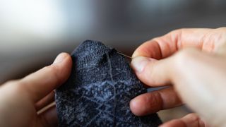 person sewing jumper