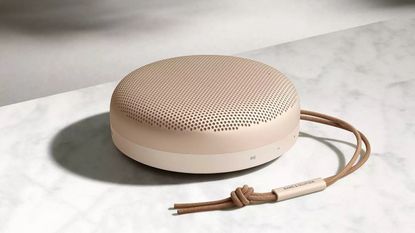 Best bathroom speaker: Bang & Olufsen Beosound A1 in pink resting on marble surface