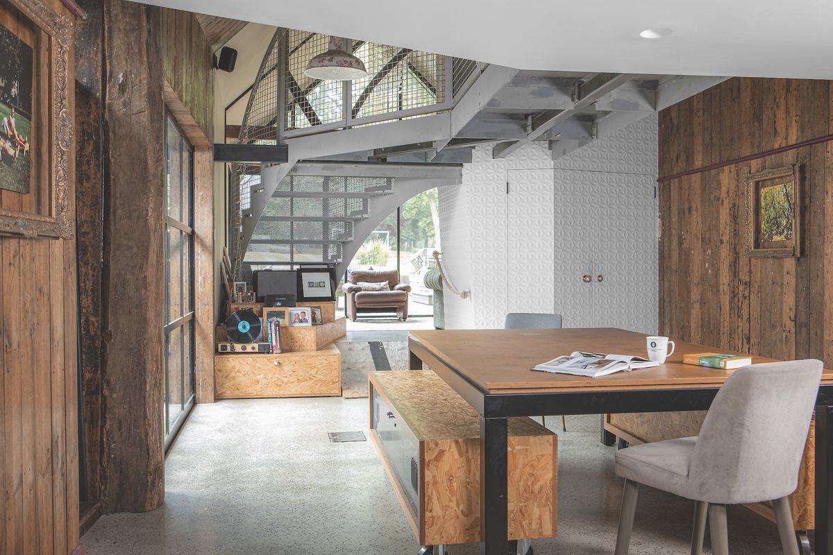 dining room with steel staircase in extension