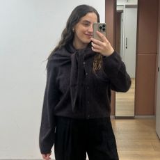 Woman wears brushed cashmere cardigan, cashmere scarf and tailored trousers