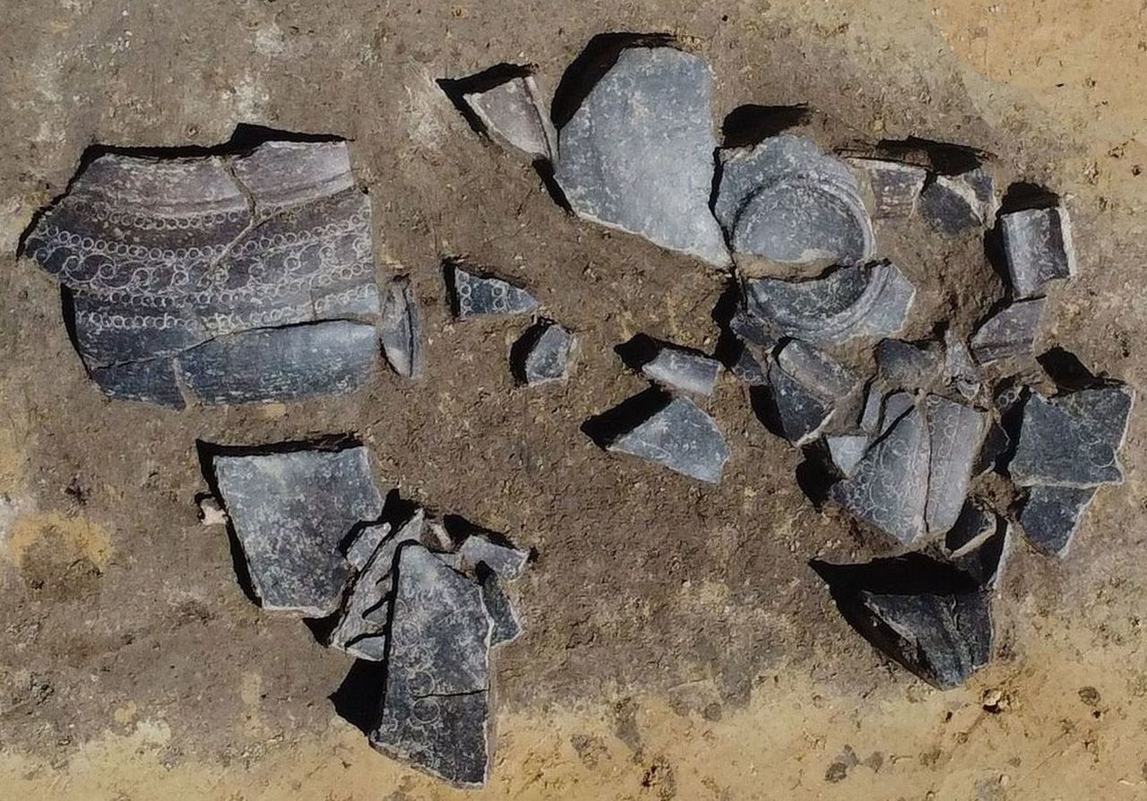 A photograph of a broken pottery jar