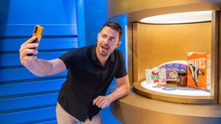 Host Jonathan Bennett takes a selfie in front of Fruit Roll-Ups, an Easy-Bake oven and a box of Wheaties.