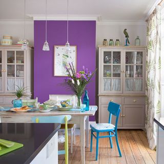 dining room with floorboard blue chair and purple wall
