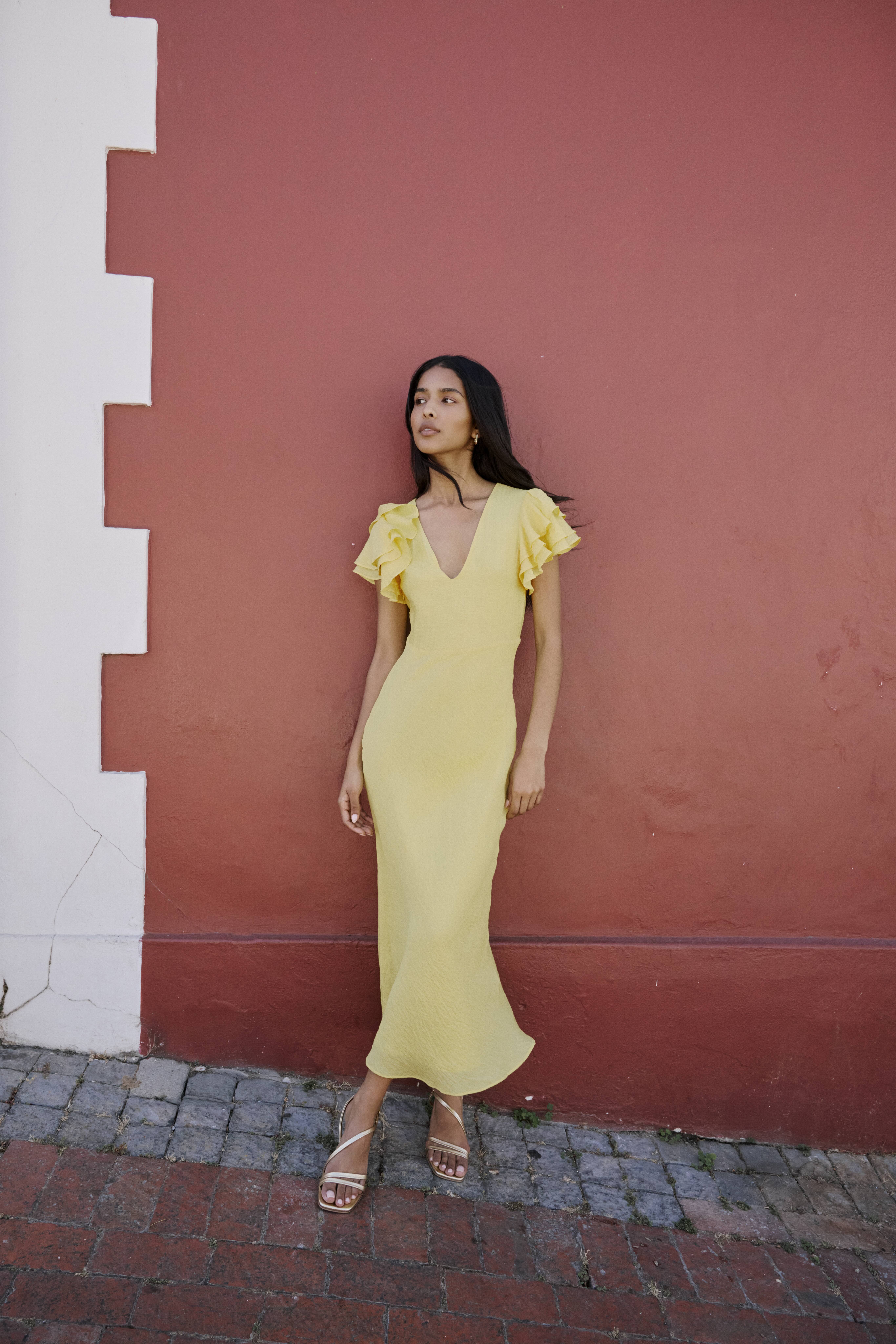 A model wears a Nobody's Child yellow bridesmaid dress.