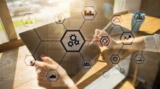 Two hands holding a tablet and stylus. Superimposed is a visualisation of a network of hexagonal nodes