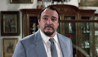 John Rhys-Davies listens intently in the study in The Living Daylights