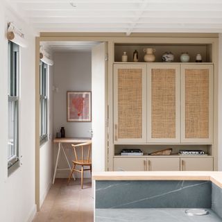 rattan storage cupboard in open plan living space with table and chair