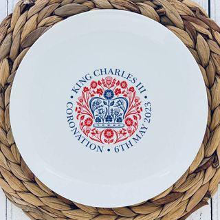 A white plate with a coronation illustration in red and blue in the center