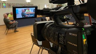 A Sony camera films a city meeting which is streamed and broadcast by Cablecast technology. 