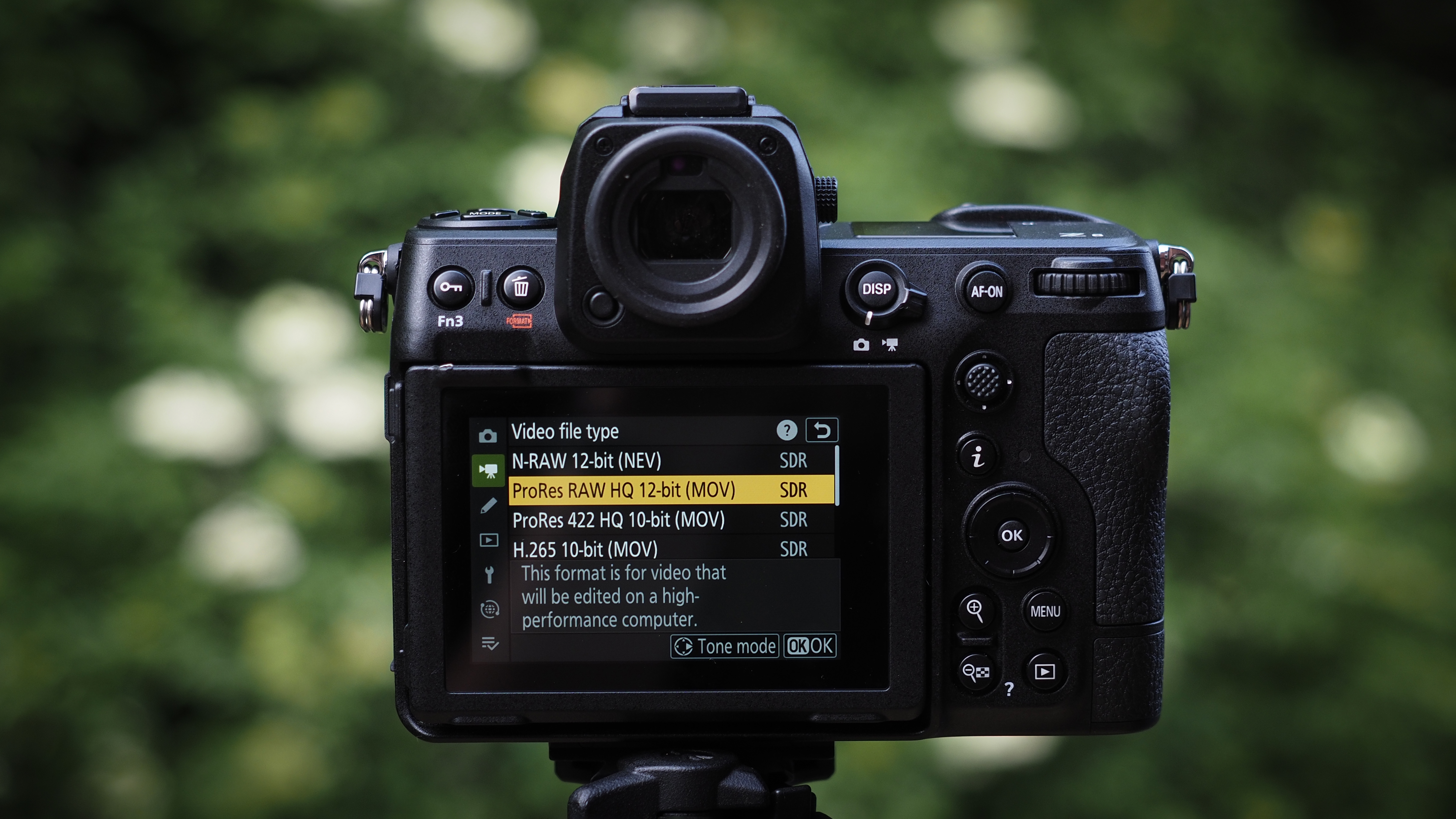 Nikon Z8 camera, pictured against a background of blurred green foliage