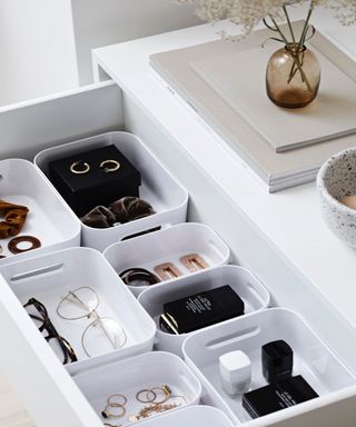 Drawer with trays holding jewelry, glasses and other accessories