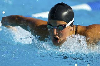A swimmer doing the butterfly stroke in the pool.