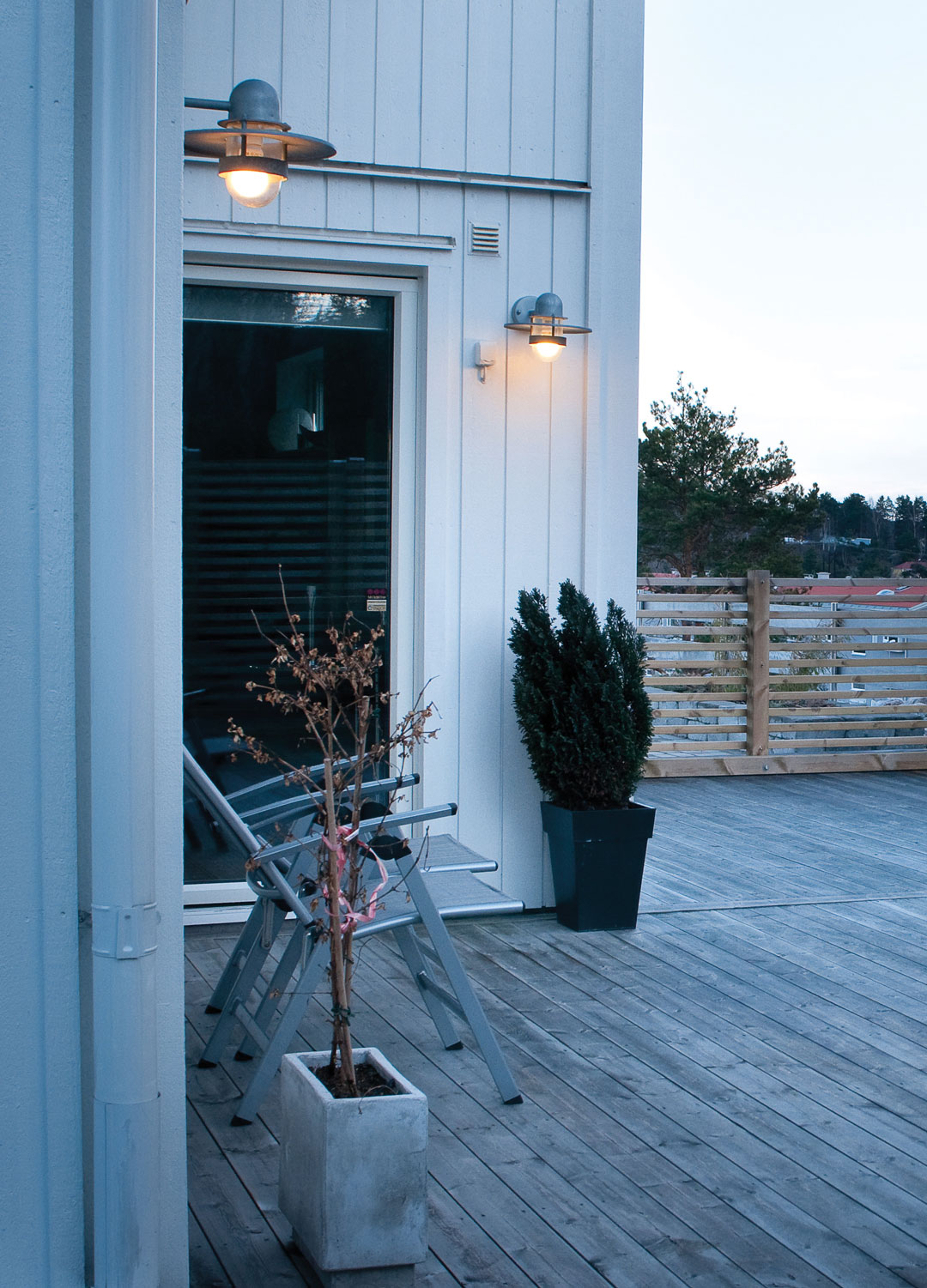 garden decking with industrial style wall lights