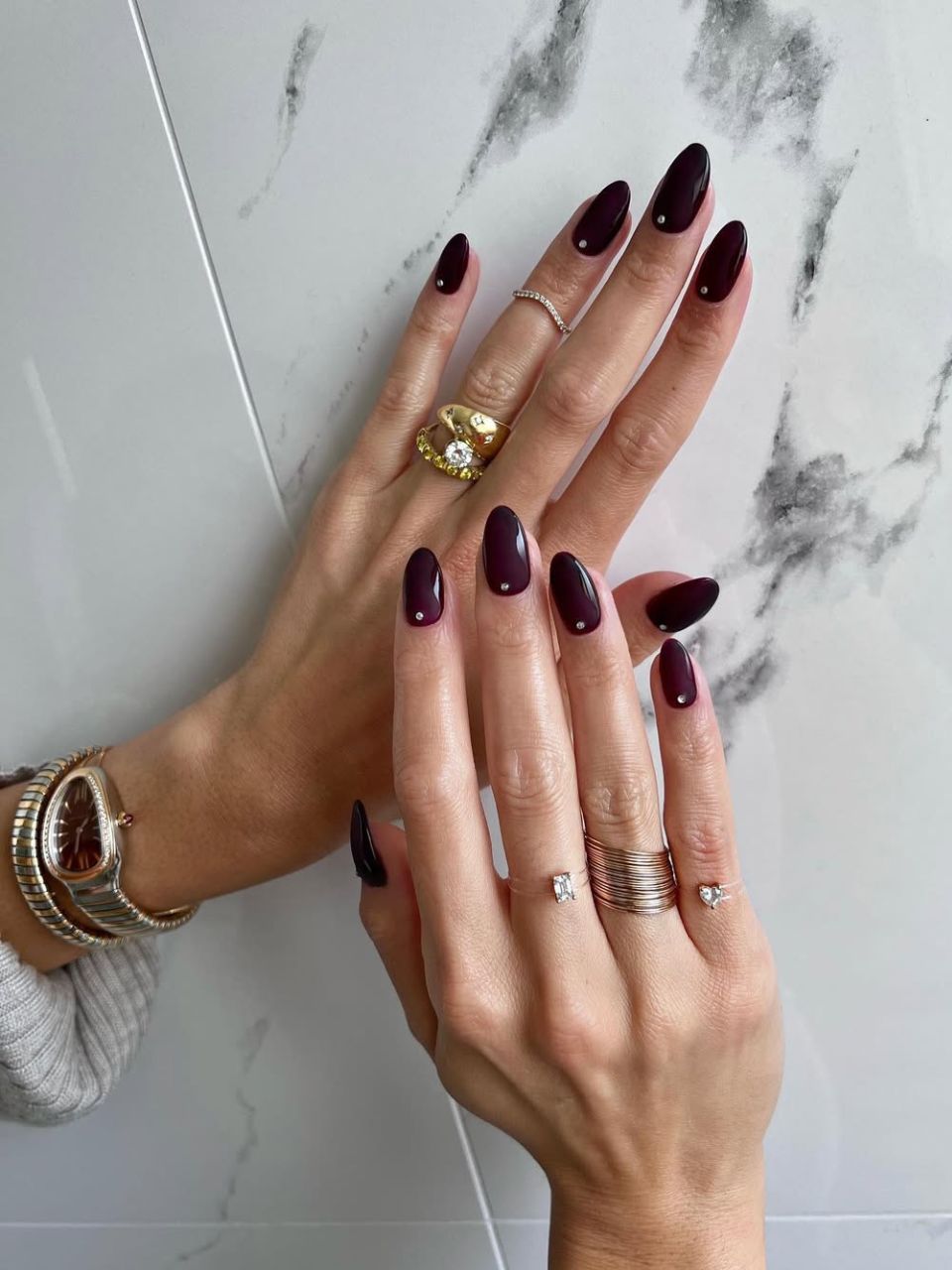 Ani mage showing a burgundy nail design, courtesy of @iramshelton