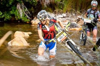 Sally Bigham and Karien Van Jaaarsveld (leading ladies) make their way through a deep river crossing during stage 3 of the 2011 Absa Cape Epic