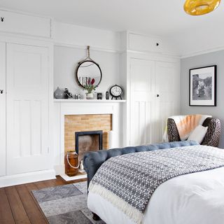 white bedroom with wardrobe and fire place