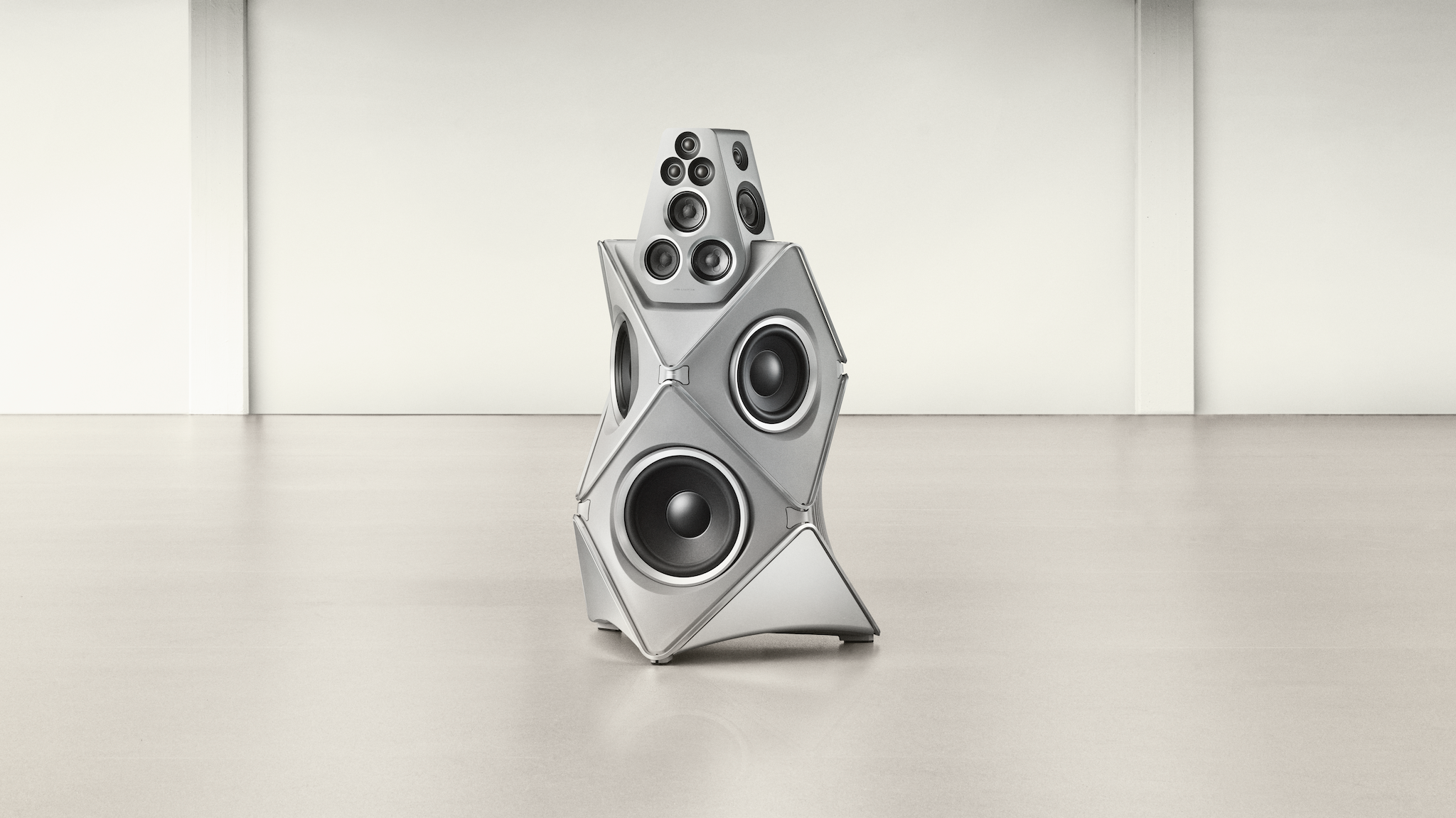 Promotional image of the Bang &amp; Olufsen Beolab 90 Titan Edition in a large, undecorated light coloured space