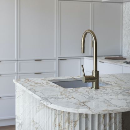 marble worktop island with fluted sides and steel tap