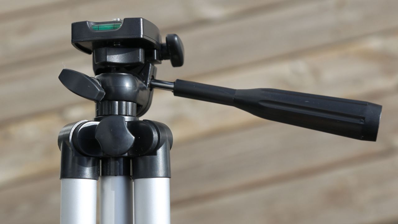The black head of a tripod.