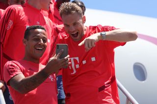 Thiago Alacantara of FC Bayern Muenchen jokes with team mate Manuel Neuer at the Los Angeles International Airport prior to depart with the team flight to Houston City during the fifth day of the FC Bayern Muenchen Audi Summer Tour 2019 on July 19, 2019 in Los Angeles, California.