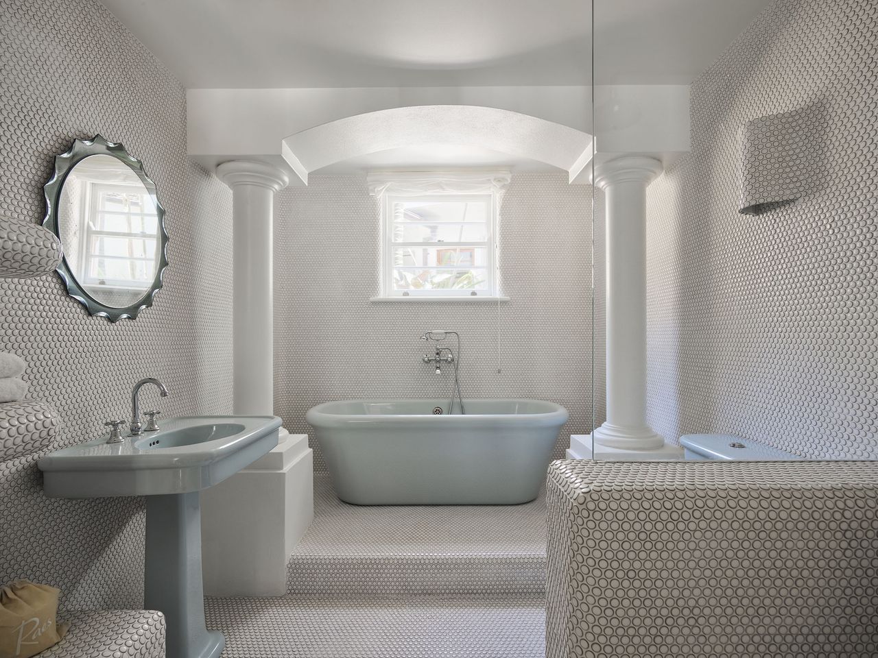 A view of the blue pastel bathtub in one of the en suite bathrooms