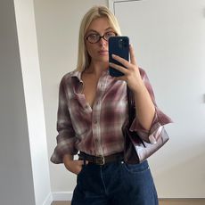 Editor Wearing Flannel Shirt and Jeans