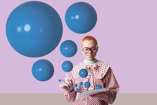 Woman stands with blue bubbles around her