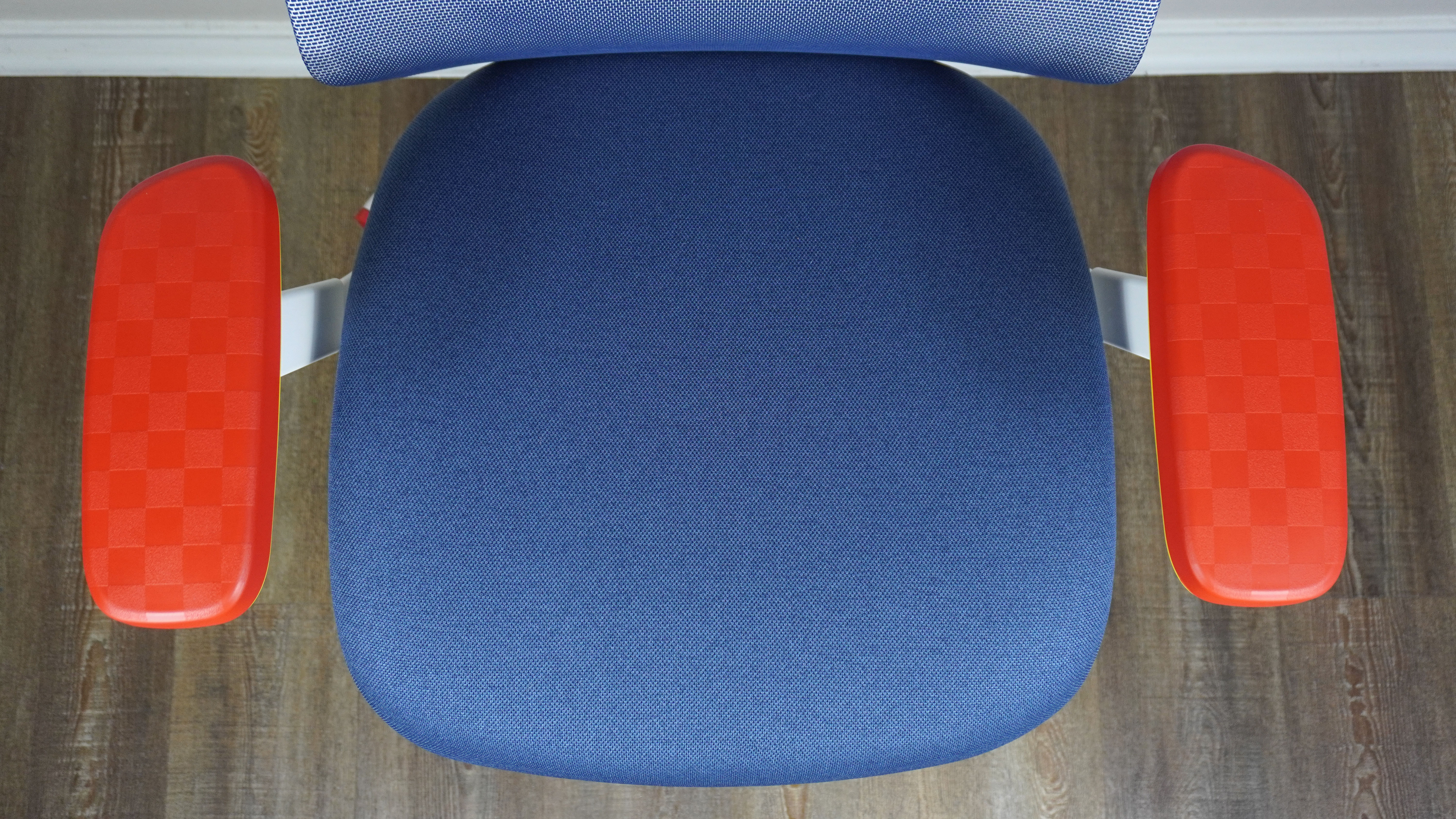 A close-up shot of the seat and armrests of the Branch Ergonomic Chair Pro: Sonic the Hedgehog Edition