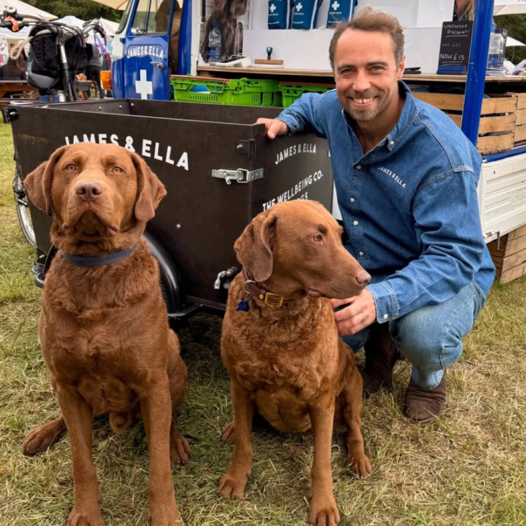 James Middleton kneeling with two dogs