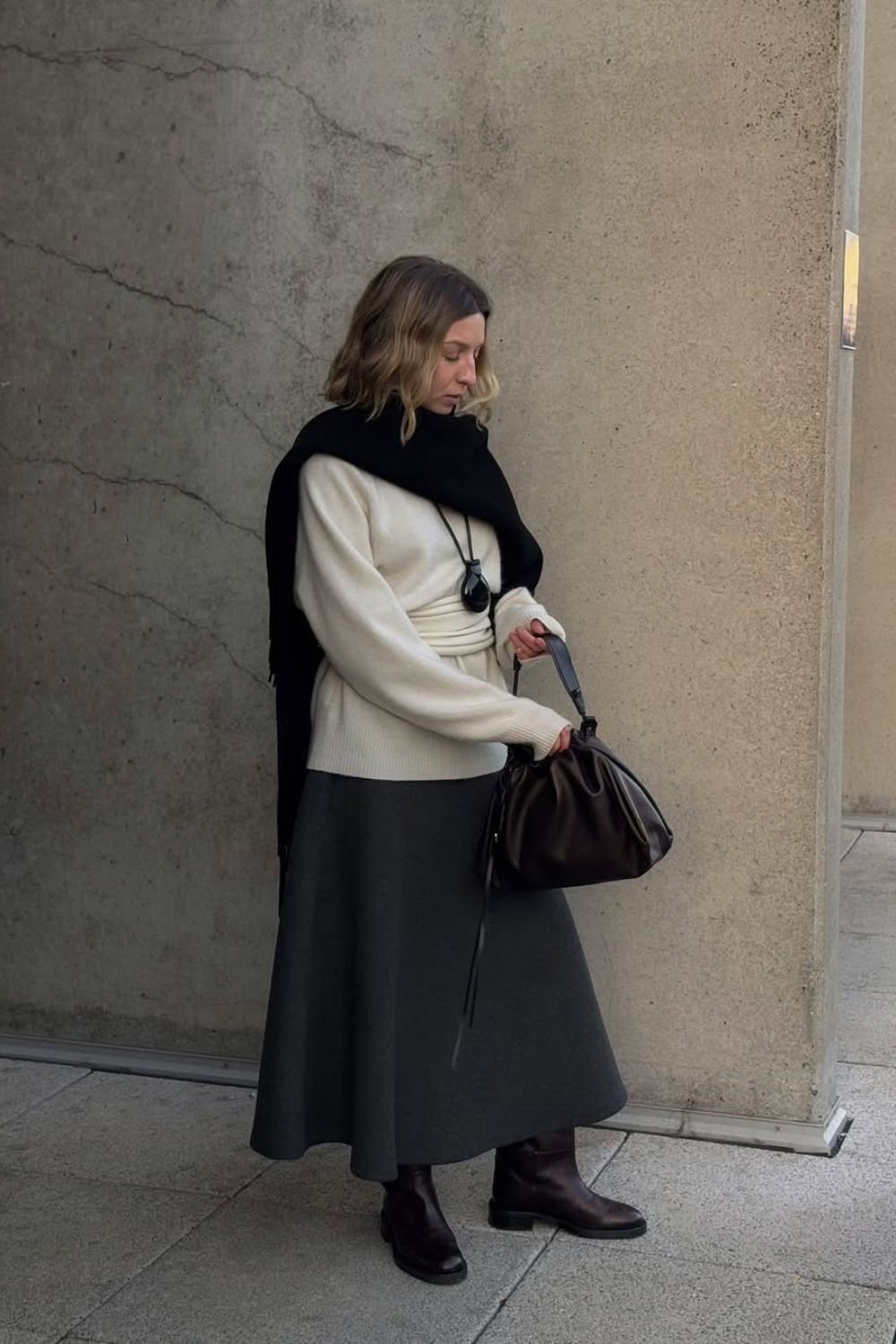 influencer wearing riding boots and winter outfit