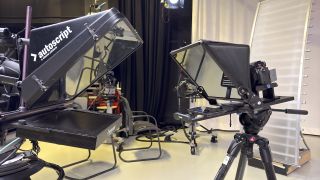 Neewer Teleprompter X14 III in a large studio next to another autoscript teleprompter